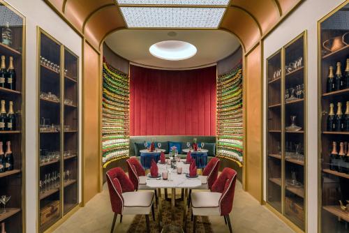 a dining room with a table and chairs and wine racks at Radisson Blu Hotel & Spa, Nashik in Nashik