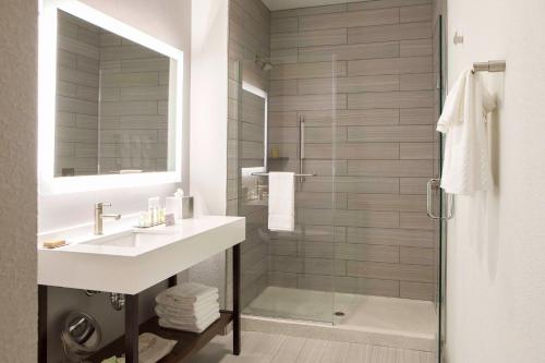 a bathroom with a sink and a shower at Hilton Garden Inn Minneapolis - University Area in Minneapolis