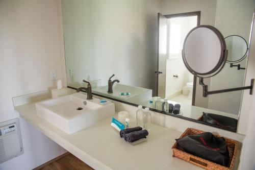a bathroom with a sink and a large mirror at Hacienda de Leal - BW Signature Collection in San Juan Bautista