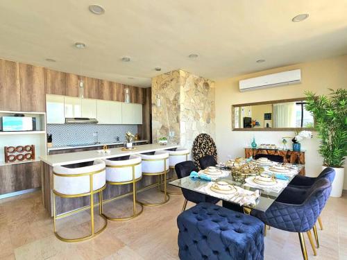 a kitchen with a table and some chairs in a room at Amazing Panoramic View from Penthouse in Pedregal in Cabo San Lucas