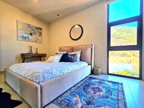 a bedroom with a large bed and a mirror at Amazing Panoramic View from Penthouse in Pedregal in Cabo San Lucas