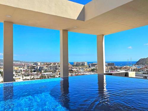 a swimming pool with a view of a city at Amazing Panoramic View from Penthouse in Pedregal in Cabo San Lucas