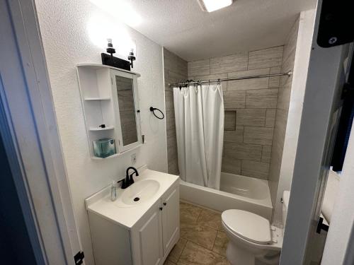 a white bathroom with a sink and a toilet at Hess St in San Antonio
