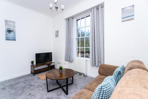 a living room with a couch and a tv at May Disc - Long Stay - Contractors in Bristol