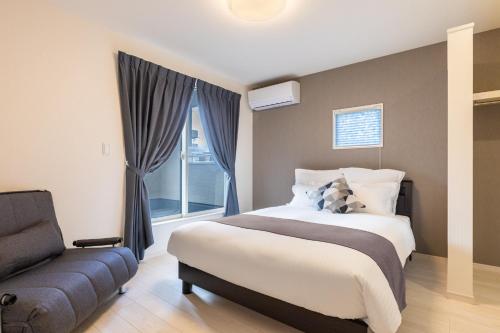 Ένα ή περισσότερα κρεβάτια σε δωμάτιο στο YADOKARI HOUSE Chatan