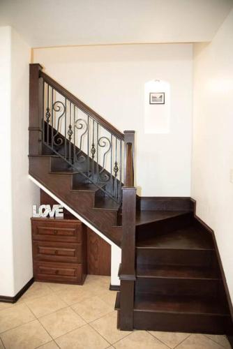 a staircase in a house with a wooden stair case at 1 Min to University UTRGV 2BD 2BT town suite in Edinburg