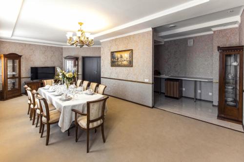 a dining room with a table and chairs at URAL TAU Hotel in Ufa