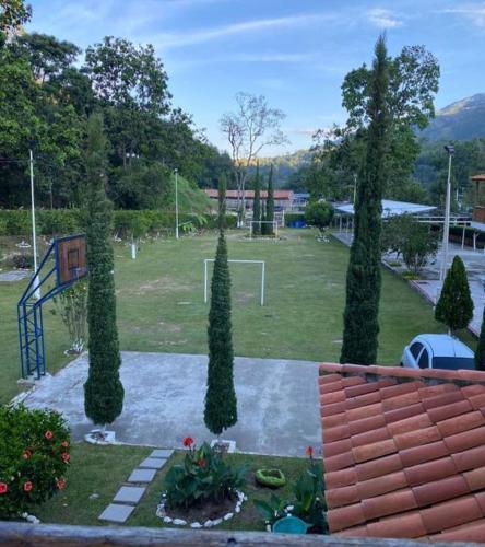 a group of trees in a park with a soccer field at Hotel Finca Villa Nathaly in Piedecuesta