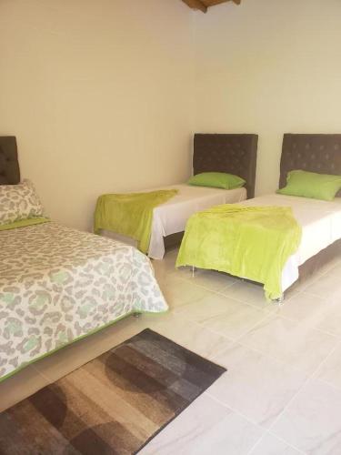 Ліжко або ліжка в номері Hotel Finca Villa Nathaly