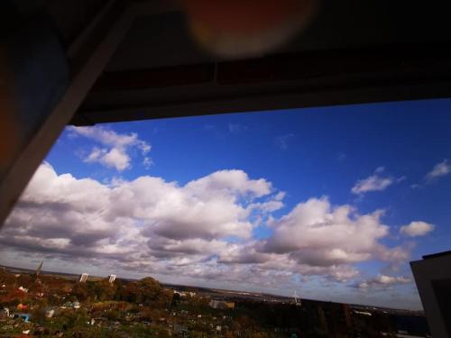 a window view of a blue sky with clouds at Unique, Stylish, Non-smoking, Riverview Loft EnSuite for Rent in Erith