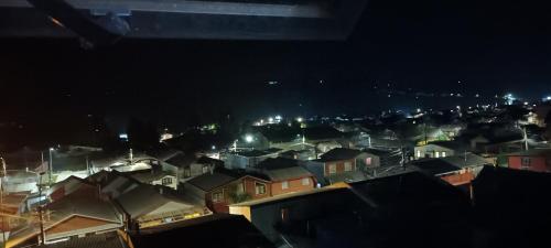 a group of houses in a city at night at Cabaña piedra azul in Dalcahue