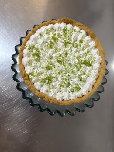 a pie on a glass plate with a green and white topping at POUSADA MINEIRA in Águas de São Pedro