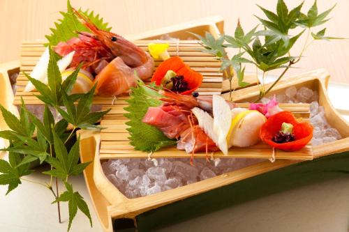 a tray of food with sushi and vegetables on it at Dantokan Kikunoya in Otsu