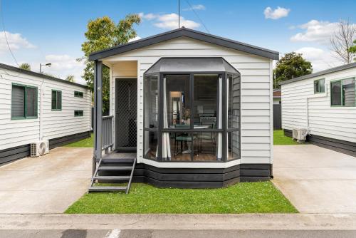 a tiny house with a window on the grass at Tasman Holiday Parks - Geelong in Geelong