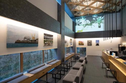 a restaurant with a row of tables and chairs at CROSS Life Hakata Yanagibashi in Fukuoka