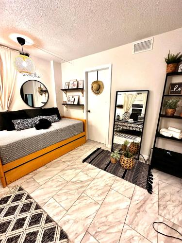 a bedroom with a bed and a mirror in it at Oversized condo Beach Oasis 601 Gorgeous Ocean front with spectacular views in Daytona Beach