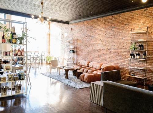 a living room with a couch and a brick wall at The Bishop Hotel in Port Townsend
