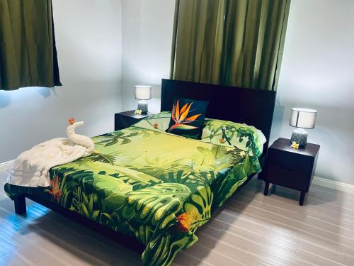 a bedroom with a bed with a bird on it at Fare To'erau - New cozy vacation home on Bora Bora in Bora Bora