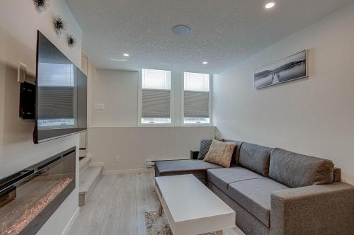a living room with a couch and a tv at Cozy New Suite in Seton, South Calgary in Calgary