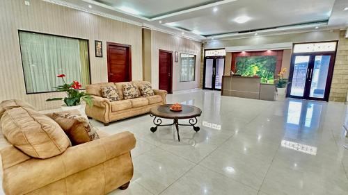 a living room with two couches and a coffee table at Homestay Pelangi Jimbaran in Jimbaran