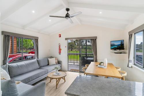 a living room with a couch and a table at Tasman Holiday Parks - Geelong in Geelong