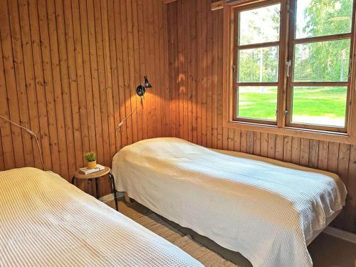 a bedroom with two beds and a window at Holiday home Aakirkeby VI in Vester Sømarken