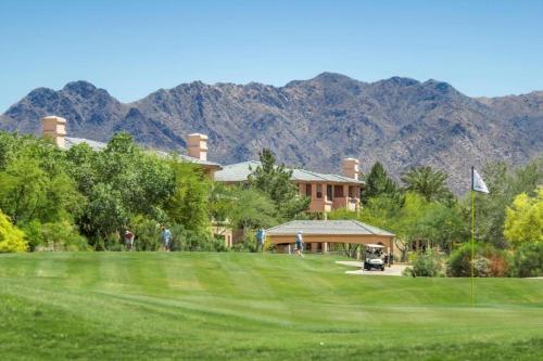 a view of a house with mountains in the background at Scottsdale Links Resort in Scottsdale