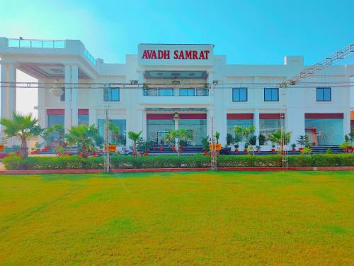 a large building with a lawn in front of it at Awadh Samrat Resort in Ayodhya