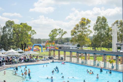 a group of people in a pool at an amusement park at Rydges Resort Hunter Valley in Lovedale