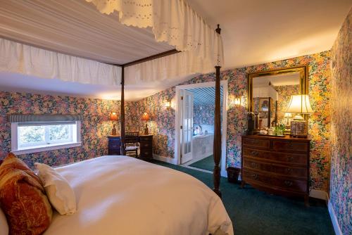 a bedroom with a large bed and a large mirror at Antrim 1844 in Taneytown