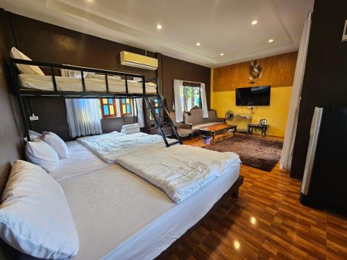 a bedroom with two bunk beds and a living room at HOMETHAI RESORT (โฮมไทยรีสอร์ท) 