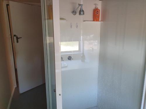 a white bathroom with a sink and a mirror at Three bedroom double lounge large house, sleeps 6 