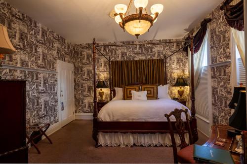a bedroom with a bed in a room with wallpaper at Antrim 1844 in Taneytown