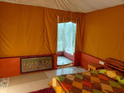 a bedroom with a bed and a window at Empyrean Tarry in Igatpuri
