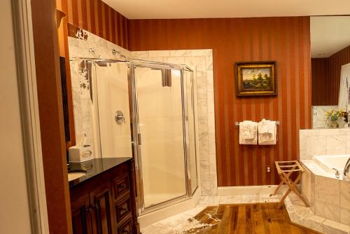 a bathroom with a shower and a sink at Antrim 1844 in Taneytown