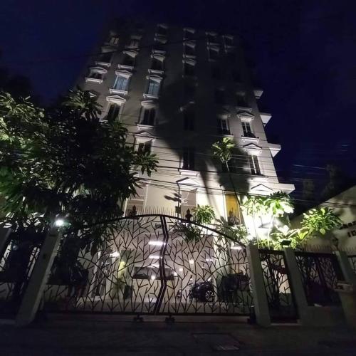 a large white building with a fence in front of it at Chez Moi Bangkok Private Executive Residence Sukhumvit 26 in Khlong Toei