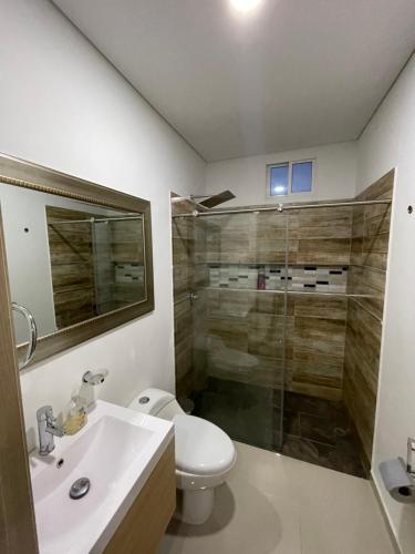 a bathroom with a toilet and a sink and a shower at apartamento en el sur de Cali in Cali