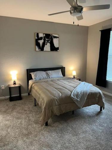 a bedroom with a bed with two tables and two lamps at Parkside at Avalon Park in Orlando