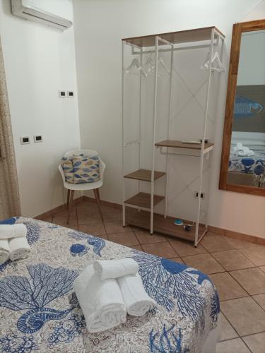 a bedroom with a bed with towels on it at ACasammare Apartment in Marsala