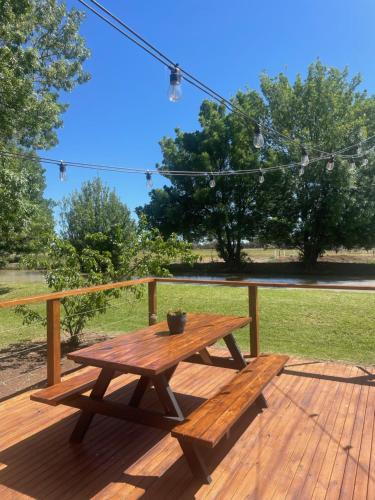 a wooden picnic table on a wooden deck at Kerang Holiday park in Kerang