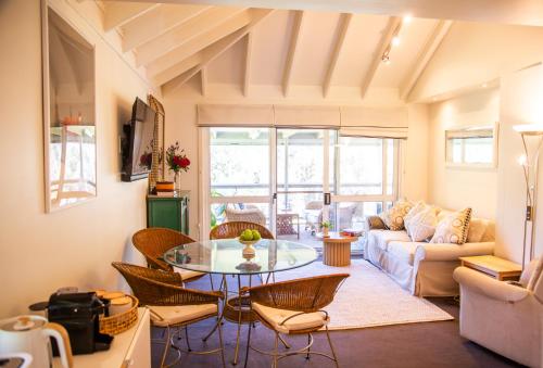a living room with a table and chairs at Chalet La Piste in Merrijig
