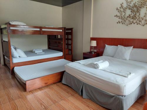 a bedroom with two bunk beds and a lamp at MaClare Resort in Imus