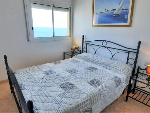 a bedroom with a bed and two windows at Apartamento Llançà, 2 dormitorios, 4 personas - ES-170-22 in Llança