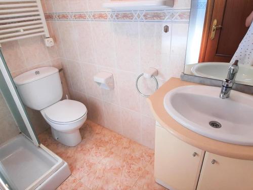 a bathroom with a toilet and a sink at Apartamento Llançà, 2 dormitorios, 4 personas - ES-170-22 in Llança