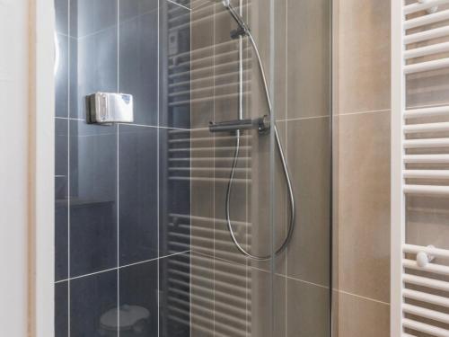 a shower with a shower head in a bathroom at Villa face à la mer avec terrasse privative, confort moderne, Wi-Fi gratuit à Saint-Nazaire - FR-1-306-1260 in Saint-Nazaire