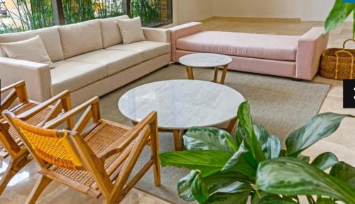 a living room with a couch and a table and chairs at Samaria club de playa Santa marta in Gaira