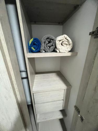 a closet with shelves with towels on it at Samaria club de playa Santa marta in Gaira