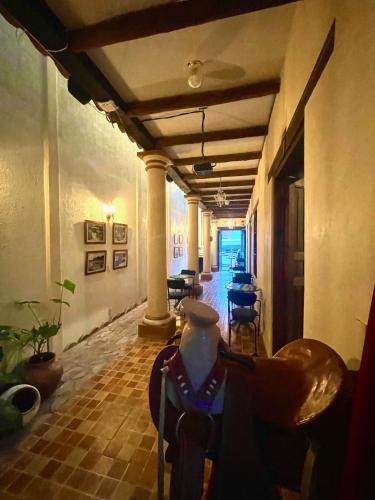 a hallway with a room with tables and chairs at Casa San Cristóbal in San Cristóbal de Las Casas
