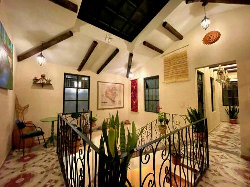 a room with a staircase with a potted plant at Casa San Cristóbal in San Cristóbal de Las Casas