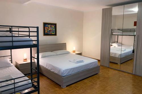 a bedroom with two bunk beds and a mirror at FiorDiLuna, nel cuore di Brescia in Brescia